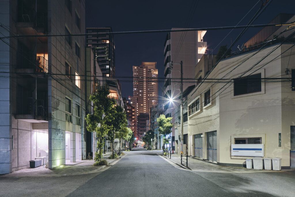 How to Find a Foreign-Friendly Real Estate Agent in Japan night scene of downtown apartment blocks, retail buildings and modern office buildings in distance, osaka, japan