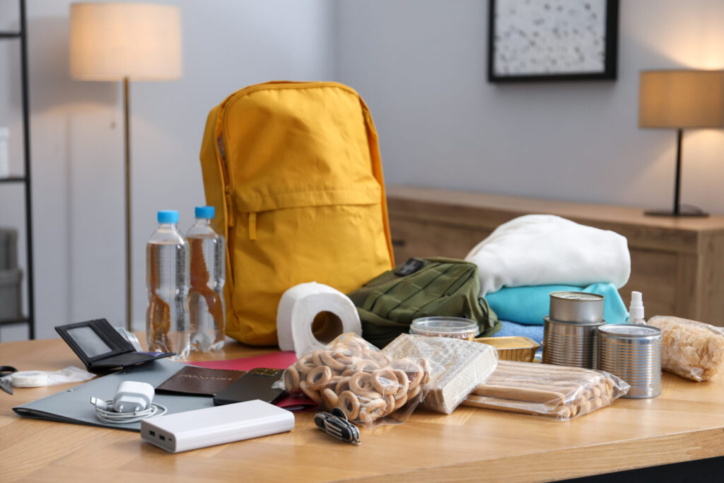 What to Do in an Earthquake in Japan: A Guide for Foreign Residents survival kit. different emergency supplies on wooden table indoors