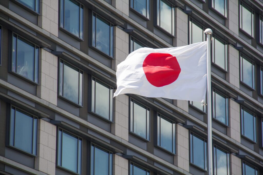 What Is a Certificate of Eligibility and Why You Need One low angle shot of the flag of japan waving in the wind in front of the buildings on a sunny day