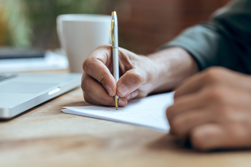 Writing a Rirekisho as a Foreign Job Seeker in Japan: A Section-by-Section Guide hand of mature business man writing some notes in notebook while