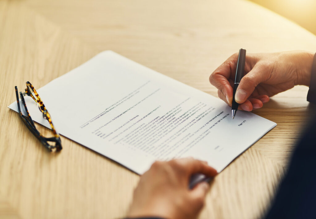 How to Read a Japanese Rental Contract Before You Sign closeup shot of an unrecognizable businesswoman completing paperwork at a desk.