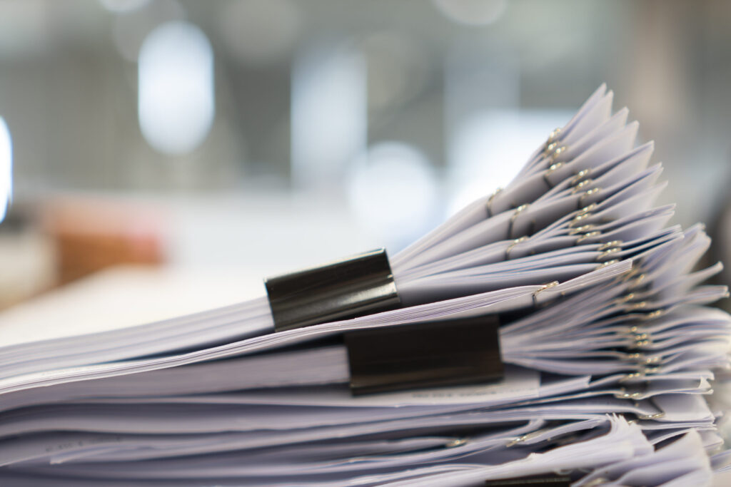 What Is a Certificate of Eligibility and Why You Need One stack of paper, document, many jobs waiting to be done on the ta
