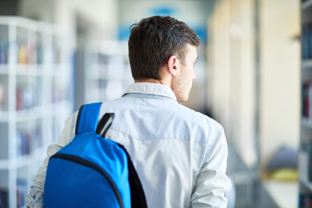University Dormitories in Japan: What to Expect and How to Apply pensive boy with satchel moving along corridor