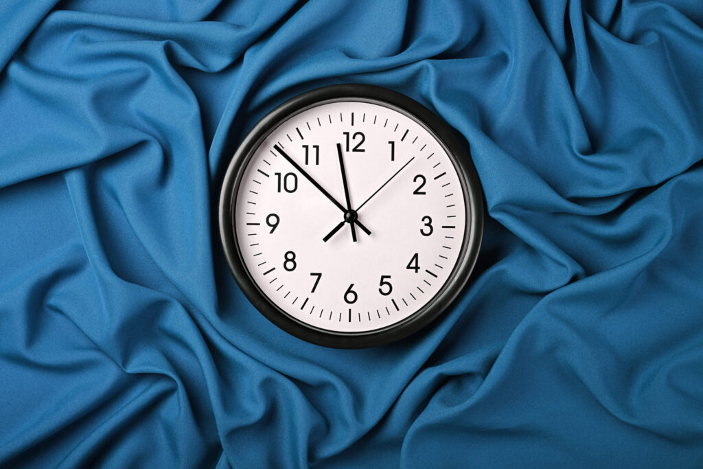 How Many Hours Can International Students Work in Japan? white clock over blue textile folded pleats