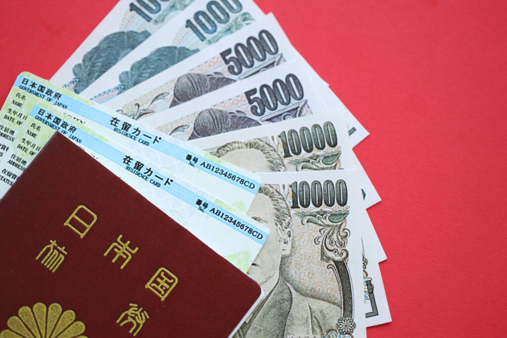 Permanent Residency in Japan: A Step-by-Step Guide green residence card of japan with passport and japanese yen money on red background