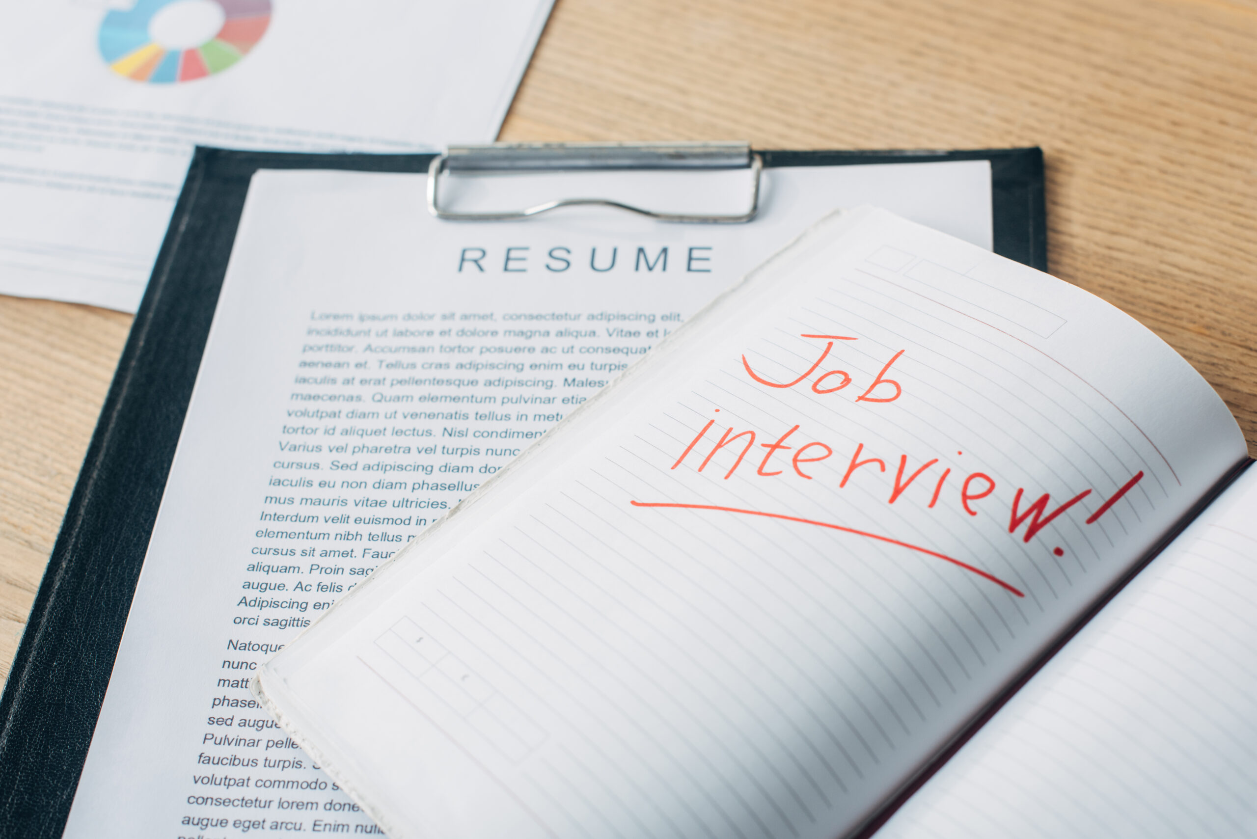 Is Job Hopping Frowned Upon in Japan? A Guide for Career Changers open notebook with job interview lettering near resume and documents on table