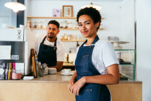 barista and waiter working in a bar cafeteria shop